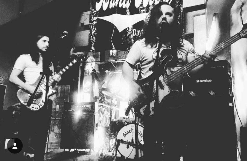 Band members performing on stage.